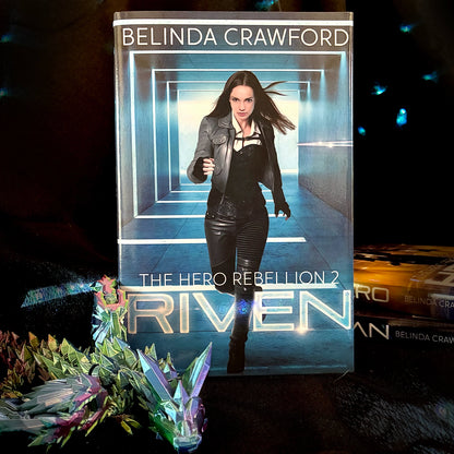 Book titled 'Riven' by Belinda Crawford with a futuristic cover design.